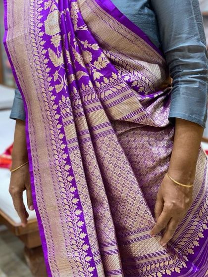 A close-up of a magnificent purple Banarasi saree, part of our 'Shades of Royalty' color palette. This is a perfect choice for a grand celebration like a sangeet or reception.