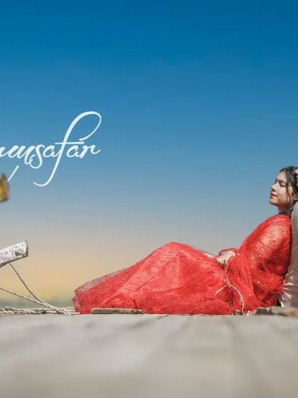 A beautiful, colorful shot of a couple relaxing by traditional boats, with "Humsafar" text, making it a perfect title page for a romantic album.