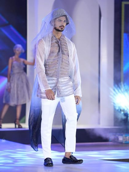 A striking avant-garde look on the runway. Modeling such creative pieces is about transforming into a character and telling the designer's story through posture and movement.