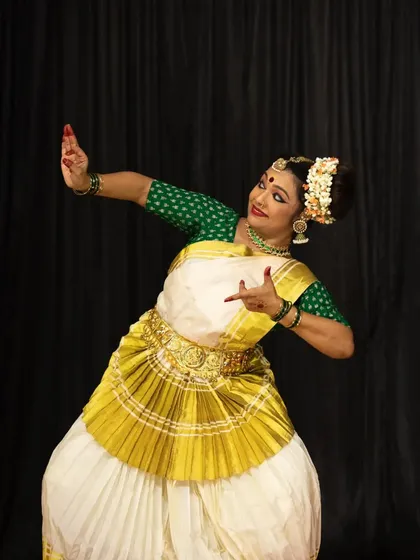 A dynamic pose from a solo Mohiniyattam recital, highlighting the unique costume and fluid body language characteristic of the art form.