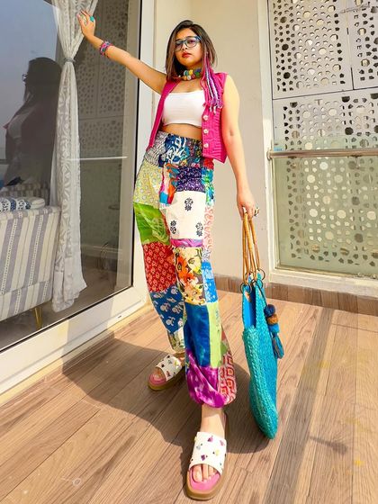 Reimagining 80s Bollywood with a modern hippie-fusion twist. These patchwork pants paired with a white tube top, a pink vest, and lots of colorful handmade jewelry create a fun, eclectic, and vibrant look.