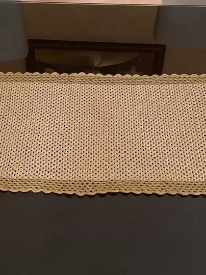The simple stitch and clean border of this gold runner make it a perfect backdrop for any centerpiece.