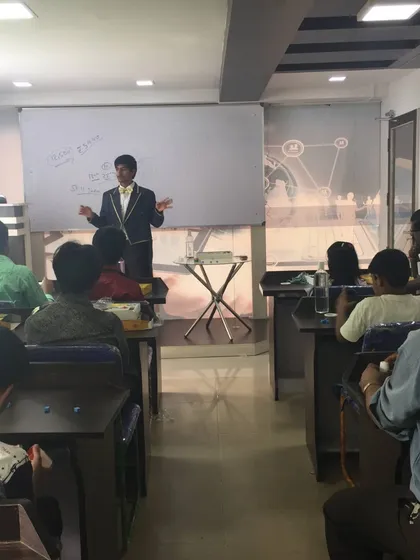 A full view of one of my magic workshops in Bangalore. We use a classroom setup with a whiteboard so I can clearly explain the secrets behind each trick before you practice it yourself.