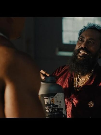 The face-off moment between Larry Wheels and Garuda Ram, where the contrasting styles of their outfits add to the scene's drama.