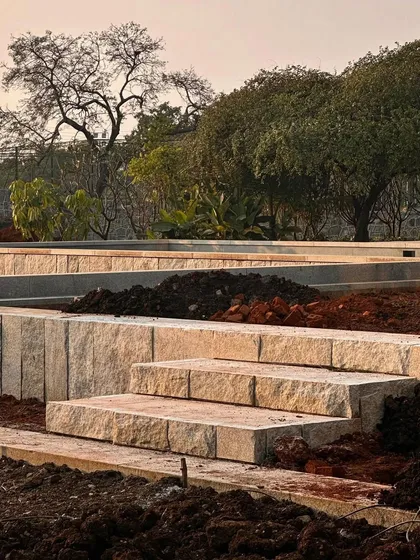 Step by step, the hardscape of an Alibaug garden takes shape. These large, hand-cut stone steps create a grand entrance and a strong connection to the earth.