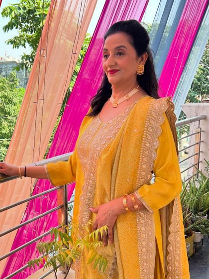 A different look for the same client on another occasion. Here she is in a vibrant yellow suit, with makeup to match the daytime event.