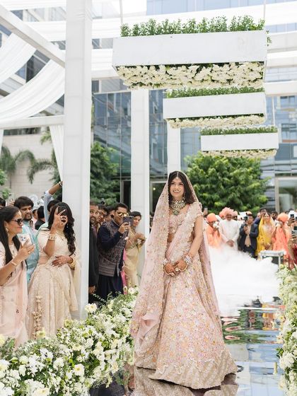 The mirrored aisle reflects the bride's ethereal look, creating a truly magical wedding scene.