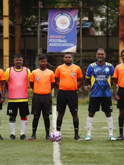 Our team captain stands with the official referees before a league match. We participate in professionally organized games, ensuring a true competitive football experience.