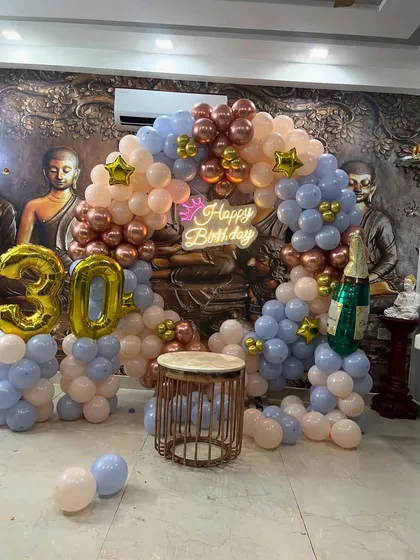 The complete setup for a 30th birthday, featuring a balloon arch, a 'Happy Birthday' neon sign, and large '30' foil balloons.