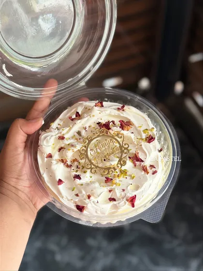My XXL Rose Tres Leches tub cake, generously topped with whipped cream, dried rose petals, and pistachios. It's perfect for sharing.