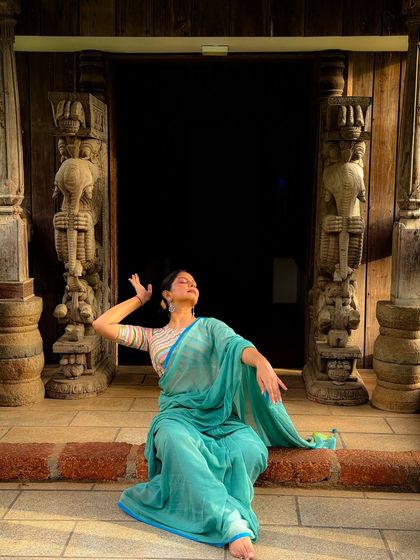 A moment of blissful surrender captured against the mystic architecture of Kerala. This image blends the beauty of dance with the heritage of the location.