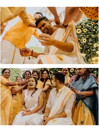 The bride and groom getting playfully doused in turmeric by their loved ones. The expressions of joy and surprise are priceless.