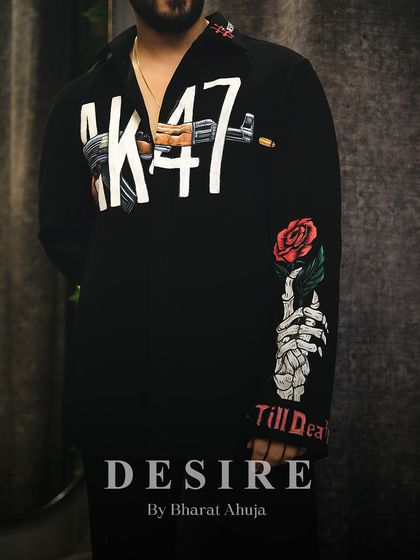 A close-up of the full design of the AK-47 shirt, from the gun graphic on the front to the skeleton hand holding a rose on the sleeve.