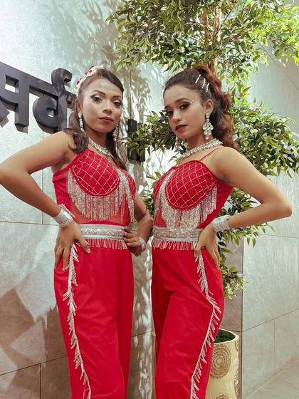 Our female dancers in their vibrant red performance outfits. The right costumes add a layer of visual excitement to the choreography.