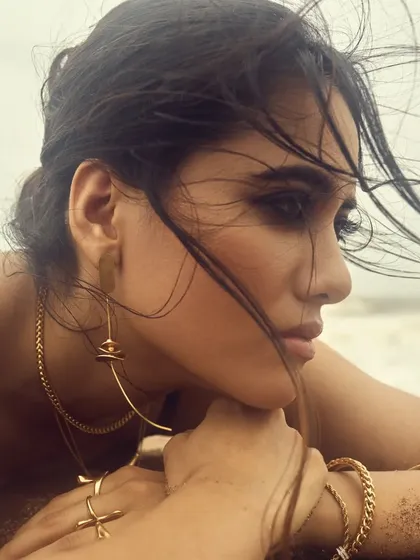 An editorial-style shot from the campaign. The makeup is designed to look flawless even with sand and sea spray.