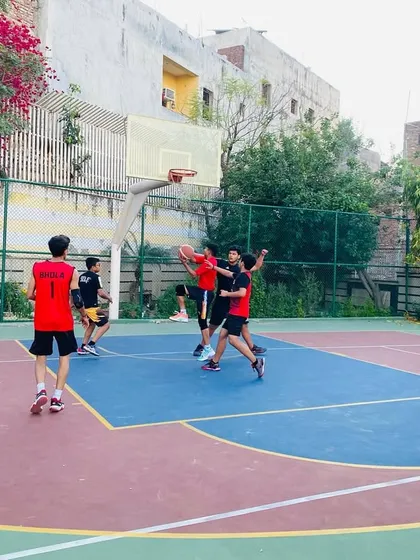 A contested shot in the paint during one of our evening games.