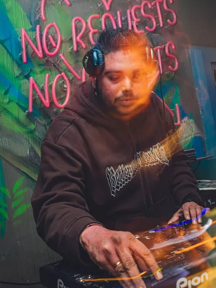 "No Requests, No Regrets." I curate a journey with my music, and this shot captures me in my element, focused on the craft.