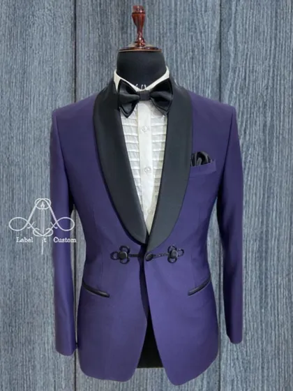 A tailor-made tuxedo is the best way to look your best on your big day. This purple tuxedo with a unique frog-closure detail is a testament to that.
