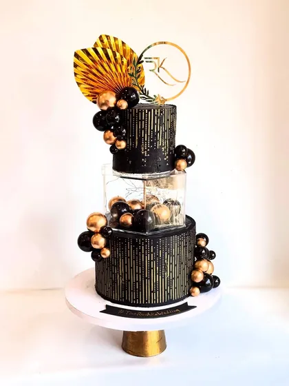 This black and gold tiered cake is the definition of modern luxury. Designed for a wedding, the clean lines, gold stenciling, and dramatic color scheme create an unforgettable statement piece that tastes as incredible as it looks.
