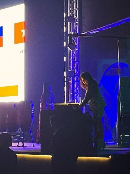 On stage and ready to perform for an international corporate audience. The flags on the screen represent the global reach of the company whose story I was about to tell.
