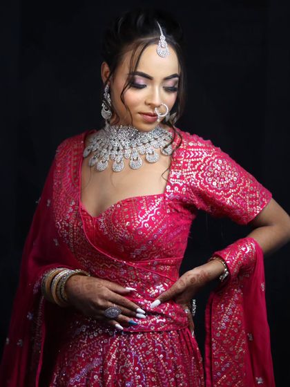 A modern bride in a shimmering pink lehenga with diamond jewelry, perfect for a reception or sangeet.