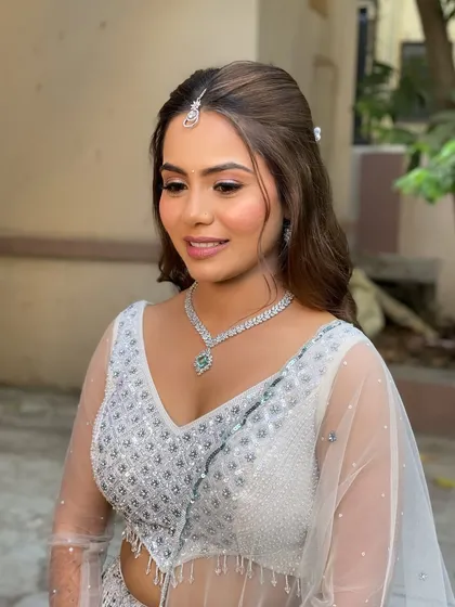 A vision in ivory, this bride's engagement makeup is all about a fresh, dewy glow. The soft eye makeup and neutral pink lip keep the look elegant and modern.