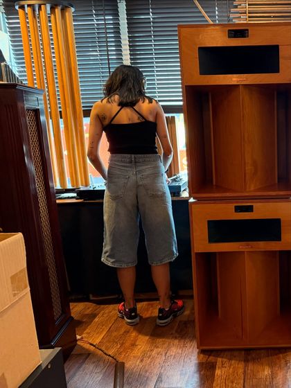 A behind-the-scenes shot from a listening session. My everyday style is a mix of denim, basics, and unique sneakers.