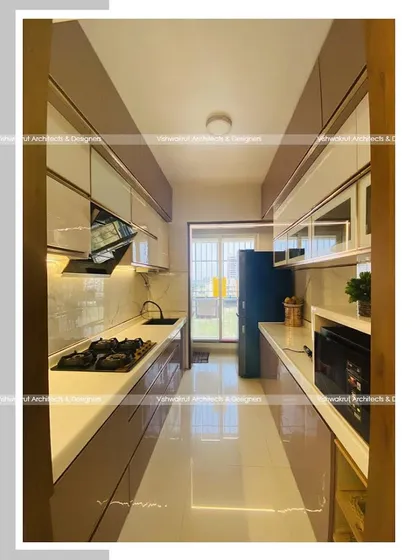 A parallel modular kitchen with an acrylic finish in our Majestic Villa project. This layout is extremely efficient, providing plenty of counter space and storage on both sides.