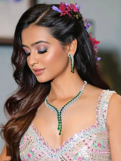 A serene portrait showcasing the delicate balance of colors in this Mehendi look. The soft eye makeup and glowing skin are the perfect complement to the intricate jewelry and pastel lehenga.