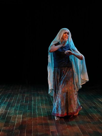 A dancer with a veil during a tech run.
