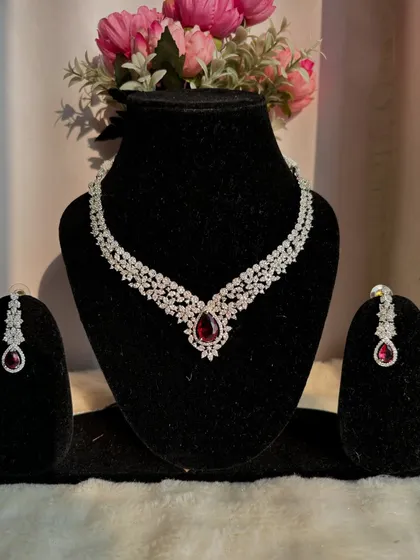 This AD necklace set with a central ruby-red stone is a showstopper. It's the perfect statement piece to elevate a simple gown or saree.