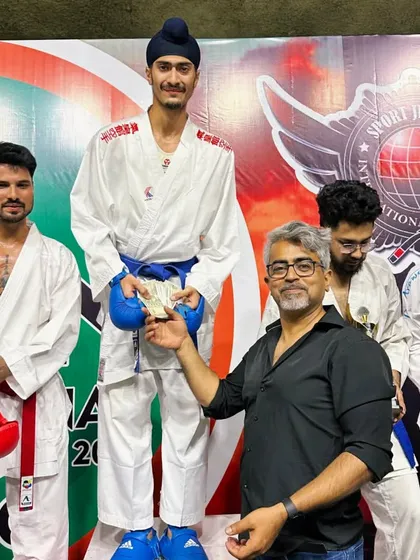 Receiving the prize money on the podium at the India Open. Professional events like these provide valuable opportunities for athletes to showcase their skills.