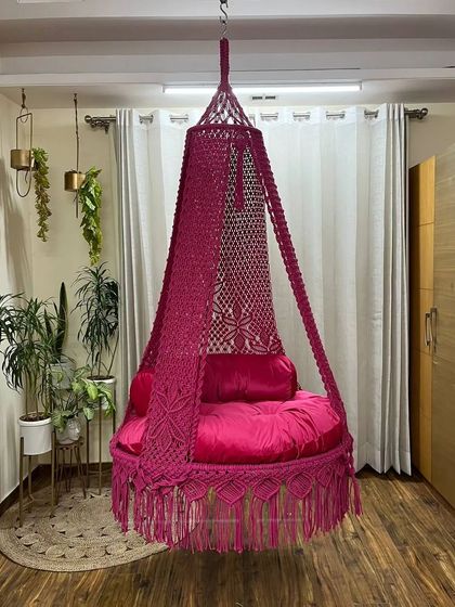 A single seater swing in a striking magenta color. The design includes our signature floral knot pattern, adding a delicate touch to the bold color.