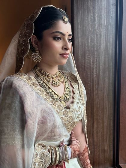 Looking out at her future. This quiet moment captures the soft elegance of Sanya's bridal style.