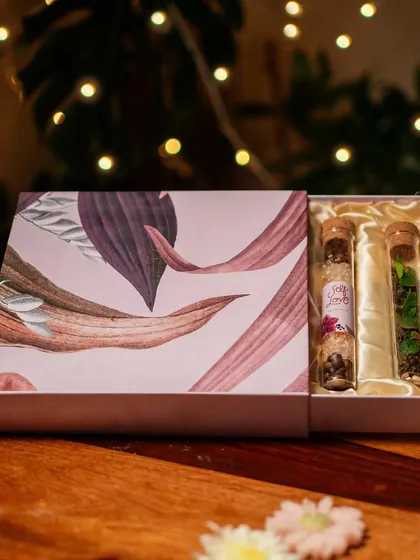 My Diwali gift box features a unique set of test tubes containing two mini terrariums and two tubes of luxurious bath salts. It's a perfect blend of home decor and self-care, designed for relaxation.