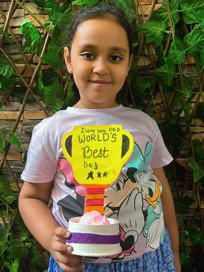 A beautiful "World's Best Dad" trophy, crafted and painted with love by a proud daughter.
