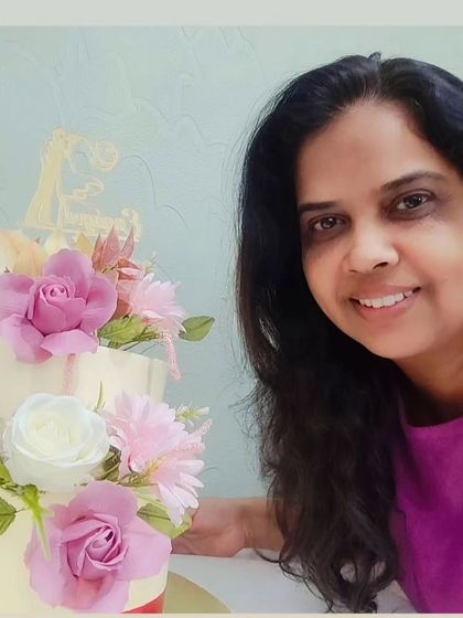 Another angle of me with the floral engagement cake, showing the detail of the sugar flowers.