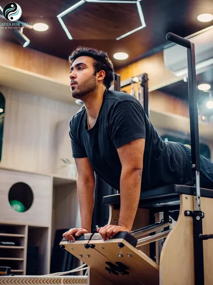 The swan is a classic Pilates exercise that strengthens the back extensors, opens the chest, and stretches the abdominals. This client is performing it on the stability chair.