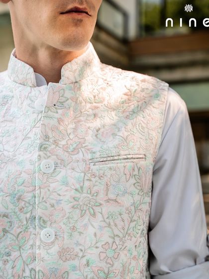 A close-up of the pastel floral vest, showing the detailed threadwork and the texture of the fabric. It’s a piece that looks even more beautiful the closer you get.