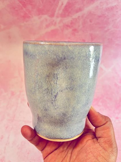 Holding one of my light purple grip mugs. The glaze is soft and subtle, with a lovely satin finish that feels great to the touch.