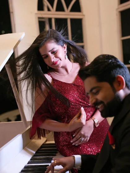 A romantic and elegant pre-wedding shot at a grand piano. The bride's flowing hair and the couple's interaction create a sense of movement and passion.
