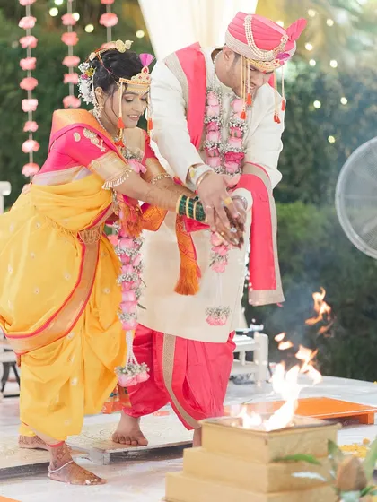 The couple taking the sacred seven steps around the fire, a pivotal moment in the ceremony.