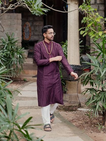 A candid shot of the groom walking through the gardens, showing the natural, unposed photo opportunities the venue provides.