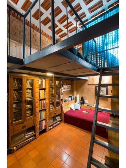 Another view of a mezzanine bedroom, showcasing the exposed tile ceiling and smart use of vertical space for storage and sleeping. This design is a core part of our passive cooling strategy, keeping the lower level cool in summer.
