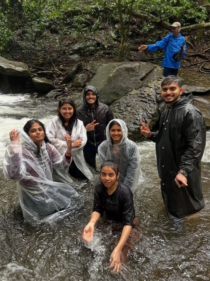 Our group having fun and cooling off in a stream during the Netravathi trek. These moments of play make the journey memorable.