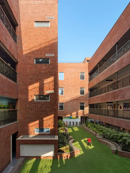 At HRM Global School in Delhi, we designed outdoor spaces to be layered and responsive. This central green court, viewed from above, shows the balance between open play areas and shaded alcoves, creating a campus that encourages exploration and spontaneity.