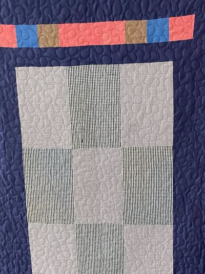 A detail shot of the shirt memory quilt, showing how different fabrics are incorporated.