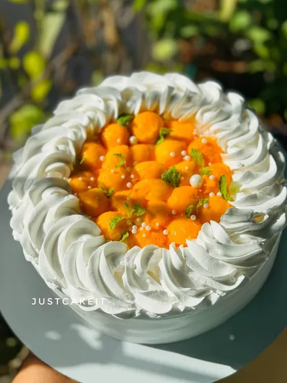 A beautiful shot of my Mango Fresh Cream cake, a true taste of the season. The top is generously covered with fresh, juicy mango pieces, making every bite delicious.