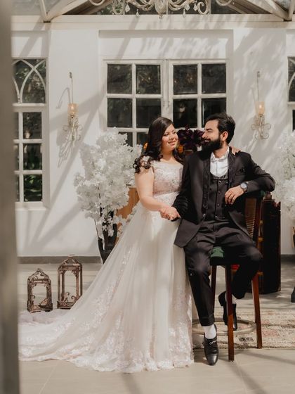 A classic pose in a beautiful glasshouse setting at Picture Villa. The couple's formal wear and the elegant white decor create a timeless and sophisticated pre-wedding photograph.