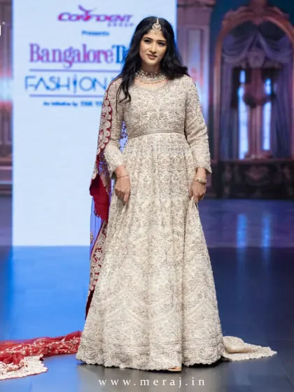 This is couture in motion. A showstopper tail gown from my runway collection, designed for the modern queen who commands attention. The intricate embellishments and dramatic silhouette redefine luxury and elegance.